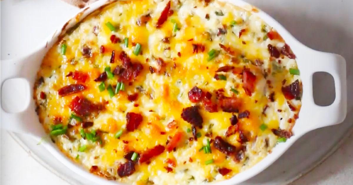 Baked cream cheese dip with bacon and cheddar bubbling in a dish, an easy party dip served with chips