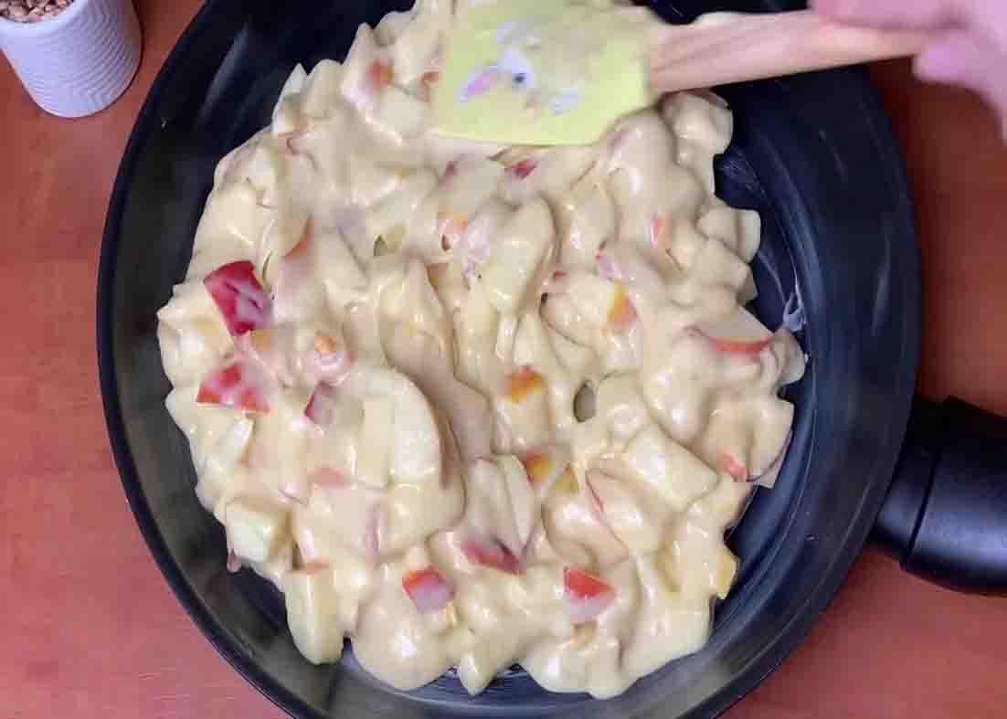 Spreading the apple pie mixture on the skillet evenly