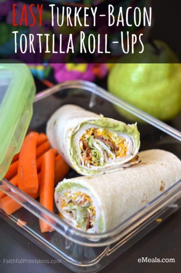 Easy turkey bacon tortilla roll ups sliced in a lunch container with celery sticks and carrot sticks
