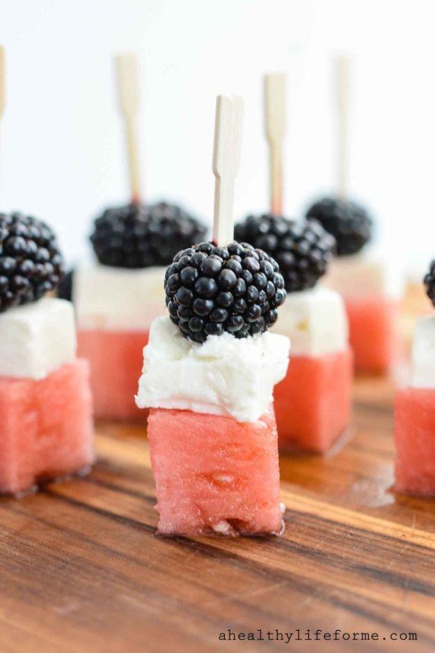 Watermelon feta blackberry skewers stacked with watermelon cubes, white feta and a blackberry on each