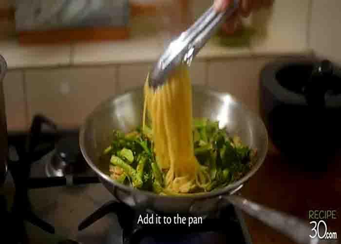 Tossing the garlic broccolini pasta in the pan