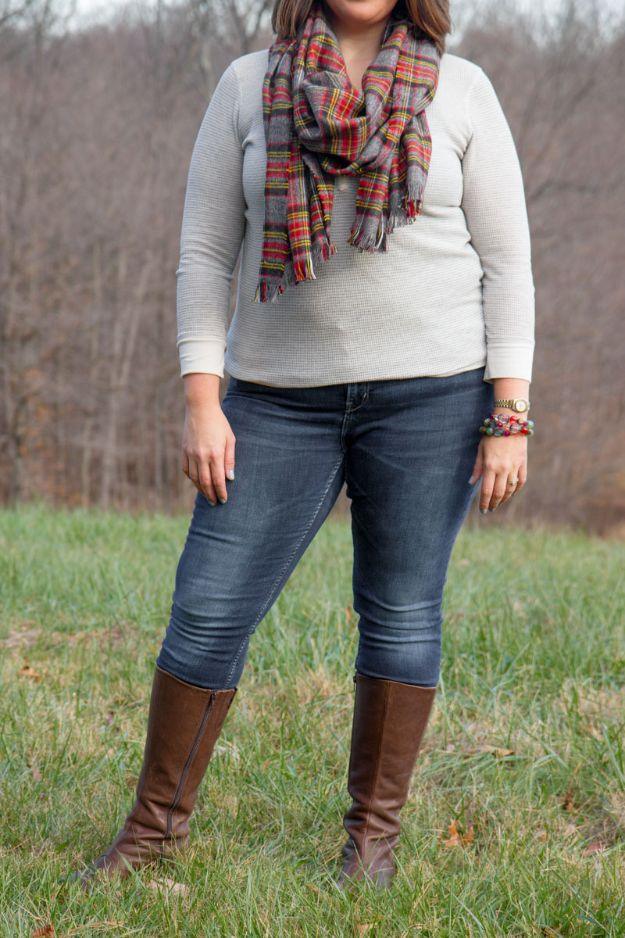 A plaid flannel blanket scarf with fringed edges folded on a chair, an easy no sew handmade gift idea
