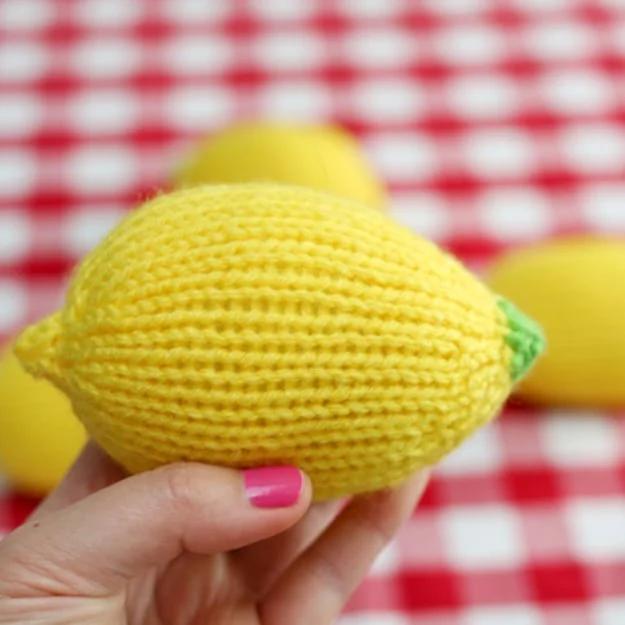 A lemon shaped stress ball knit and stuffed for a cheerful handmade desk accessory gift for the whole family