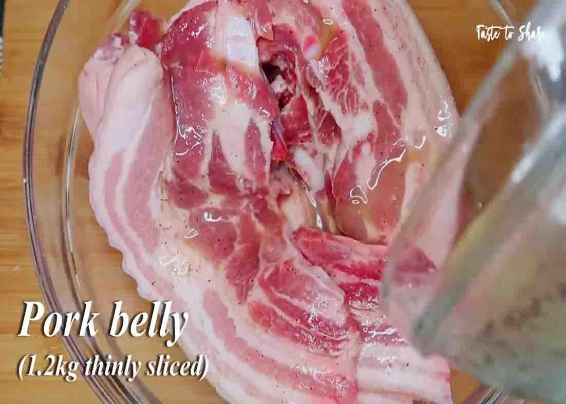 Marinating the pork bellies with the vinegar mixture