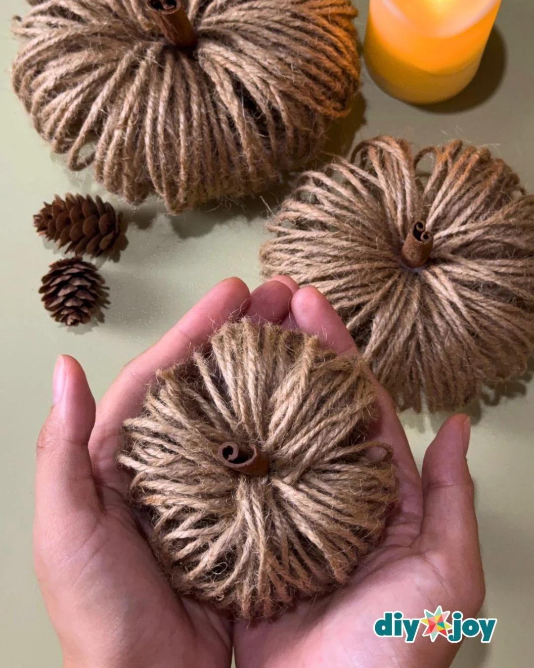 Easy fall crafts for adults - closeup of a twine pumpkin showing the wrapped jute loops and cinnamon stick stem.