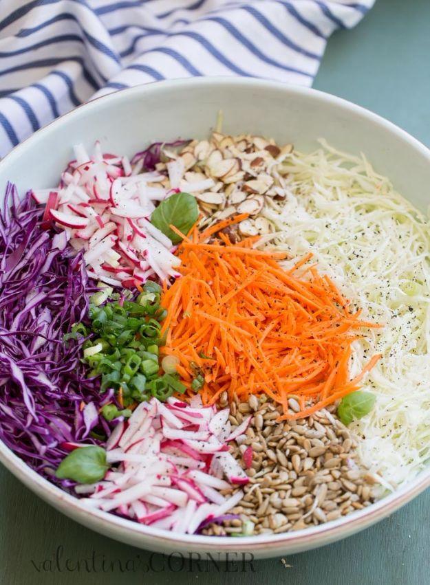 Crunchy cabbage salad in a bowl with shredded green and red cabbage, carrot, radish and sunflower seeds