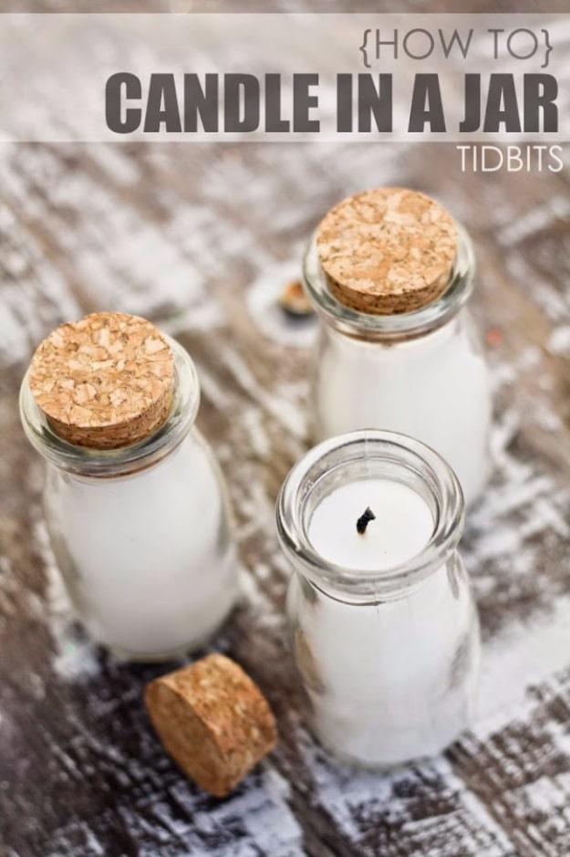 Soy wax poured into a clear glass jar with a cotton wick, burning beside a thermometer on a side table