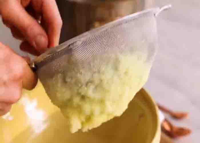 Passing the potatoes through a fine mesh sieve