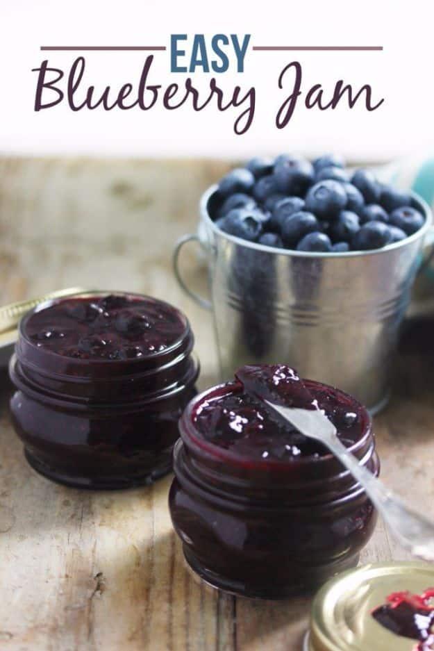 Easy blueberry chia seed jam in a small jar, thick and dark, with fresh blueberries and a spoon alongside
