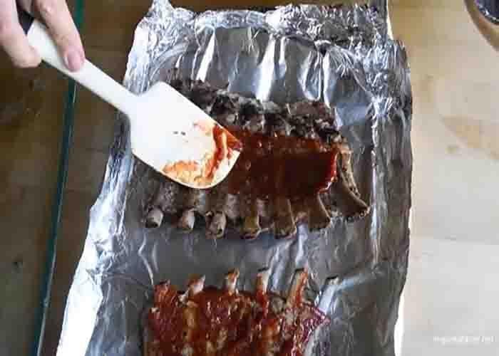 Adding the sauce to the oven-baked ribs