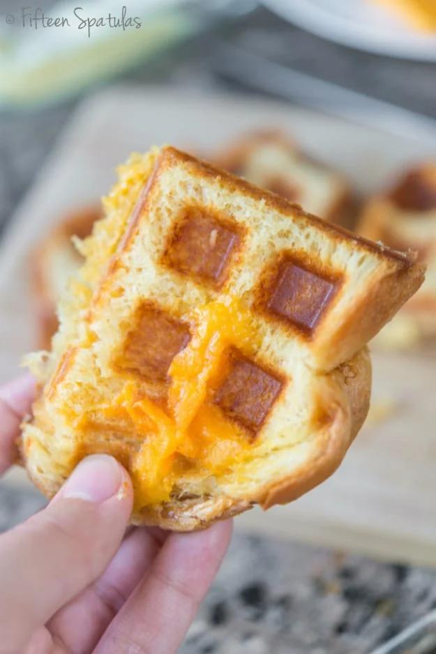 Grilled cheese sandwich pressed in a waffle iron, golden ridged bread with melted cheddar at the edges