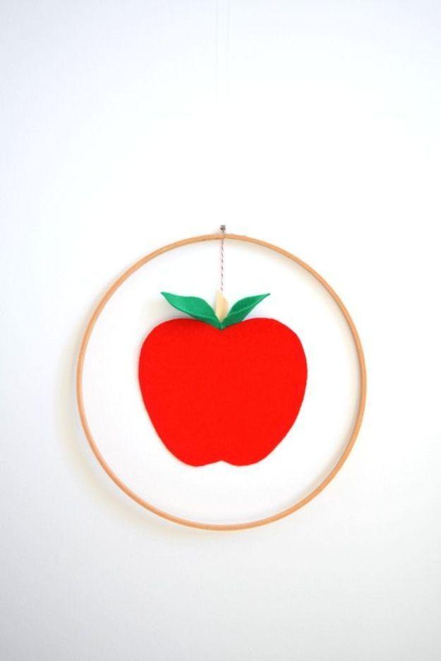 DIY apple craft with creative seasonal tutorial and rustic autumn home accent, showing the finished apple mobile wreath