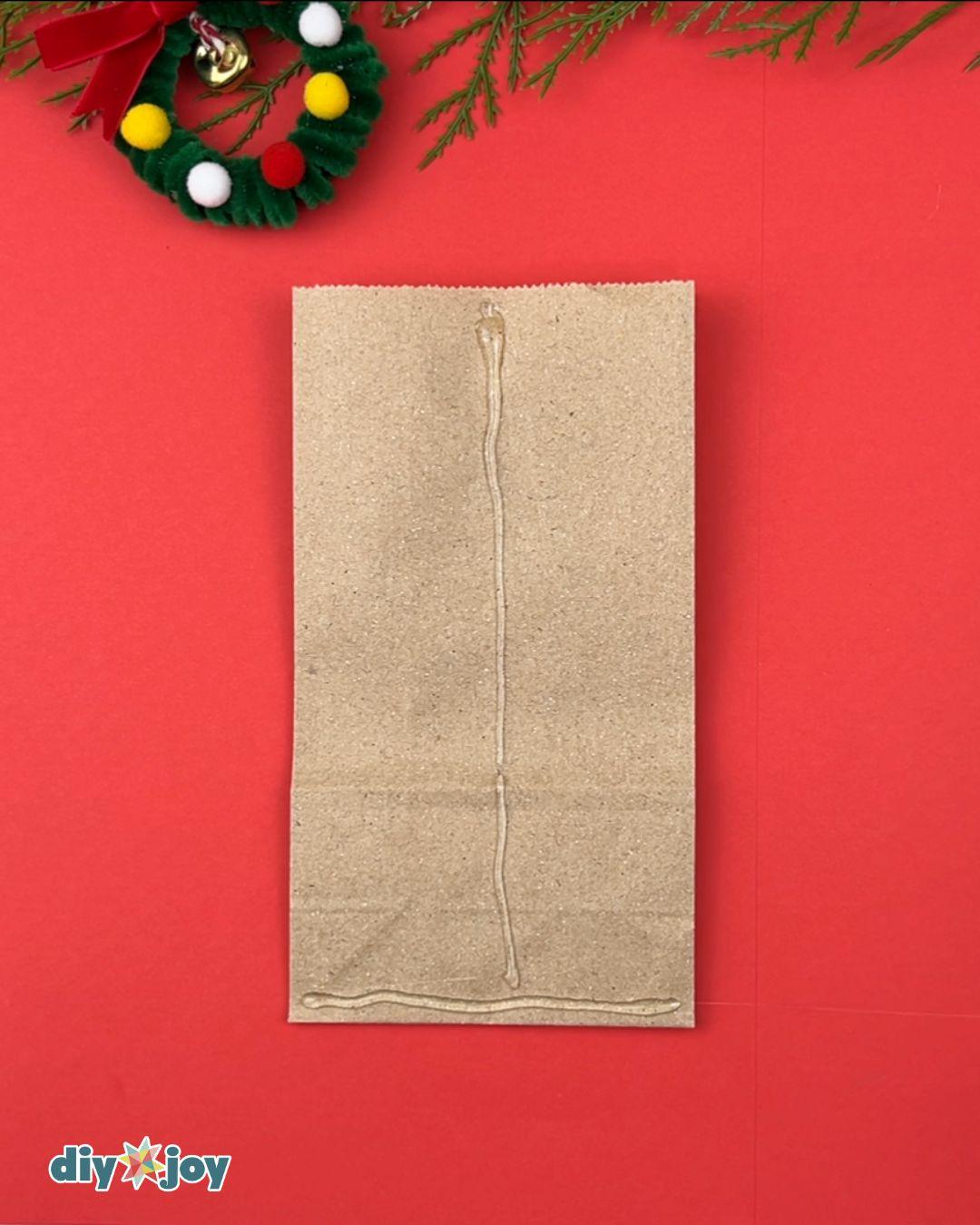Homemade Snowflake Paper Bags — gluing the paper bags