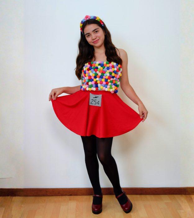 Woman wearing a multicolor pom-pom gumball top, matching headband and red circle skirt with a 25-cent label