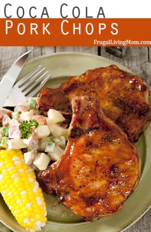 Coca Cola pork chops, a glazed chop on a green plate served with corn on the cob and creamy potato salad