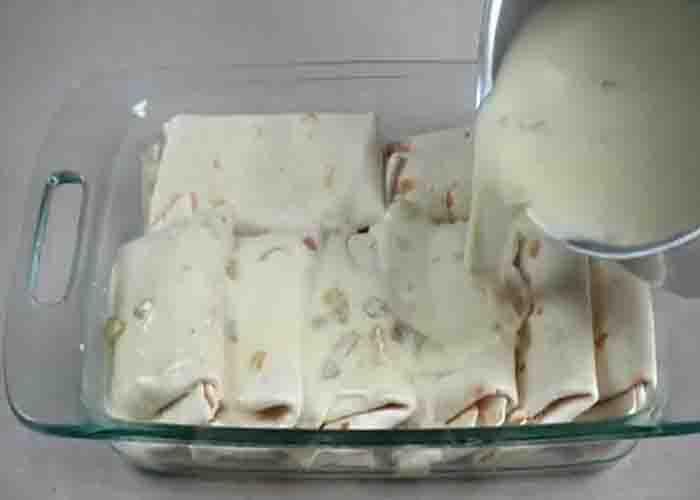 Assembling the white chicken enchilada casserole