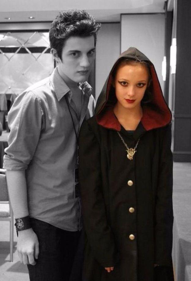 Edward Cullen and Jane couples costume with a gray hooded cloak lined in red, gold buttons and a crest pendant