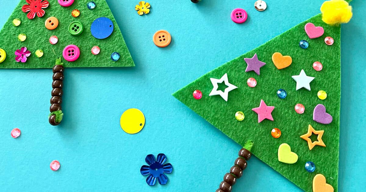 Green felt trees on beaded pipe cleaner trunks decorated with buttons, foam stars and gems on a turquoise background