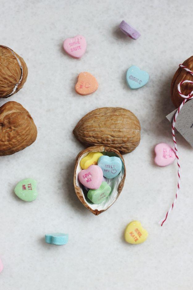 A walnut shell opened to reveal a tiny rolled note inside, a nuts about you handmade Valentine gift idea