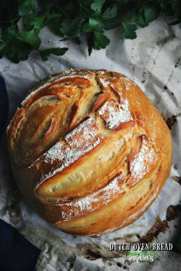Round loaf of homemade dutch oven bread with a crackly golden crust, made with a soft milk based dough