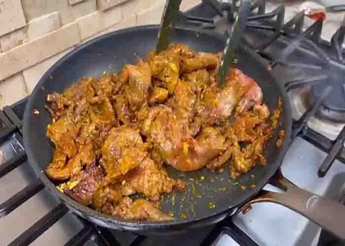 Stir-frying the beef in curry