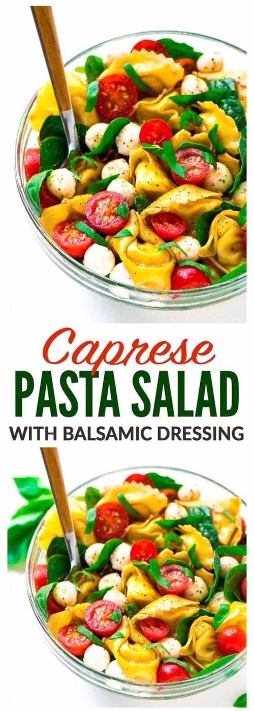 Caprese pasta salad with cheese tortellini, cherry tomatoes, mozzarella pearls and basil in glass bowls