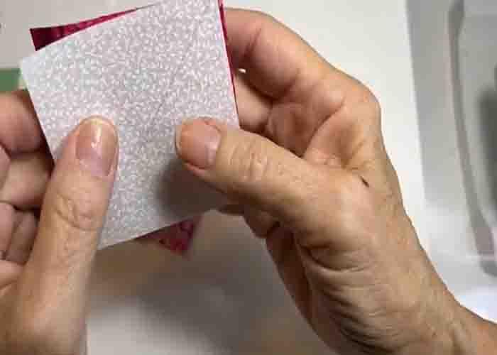Sewing the pieces together to create half-square triangles for the tulip block