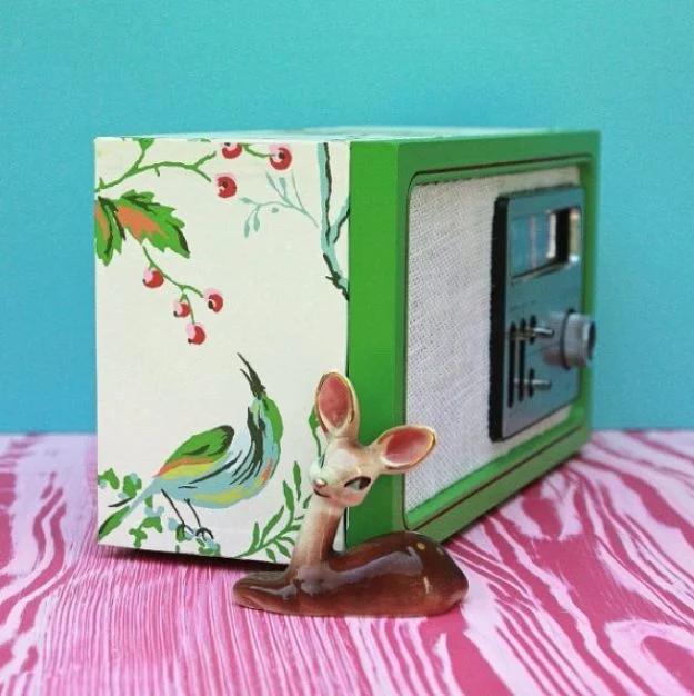 Upcycled wallpaper covered radio, a green vintage radio papered in a bird and berry print with a small ceramic deer beside it