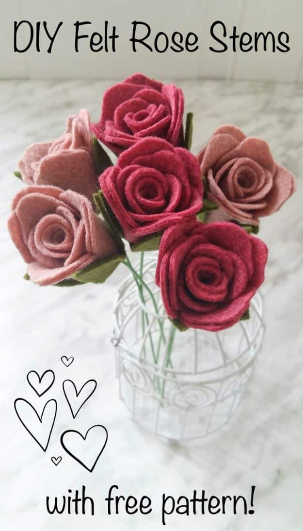 Felt rose stems in dusty pink and raspberry with green wire stems standing in a small white wire basket