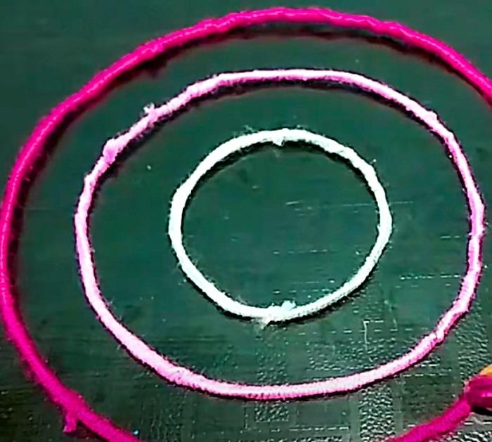 Use yarn covered floral wire to make a pom pom chandelier