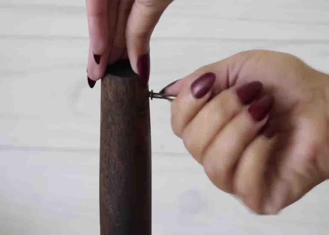 Screwing the hooks to finish the dollar tree mug holder