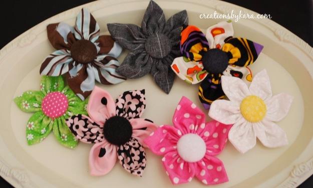 A layered fabric flower with singed petal edges and a button center, pinned in loose hair, Etsy crafts to sell