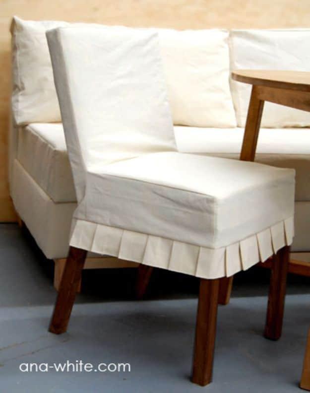 Parson dining chair with a natural drop cloth slipcover finished in crisp knife pleats over dark wooden legs