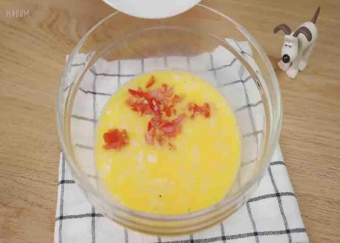 Mixing the beaten eggs, tomatoes, and onions