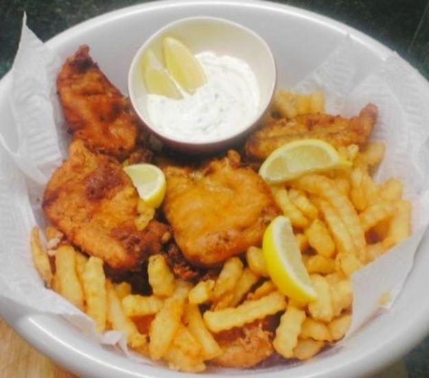 Tyler Florence fish and chips with tartar sauce and lemon wedges in a paper lined bowl, a celebrity recipe