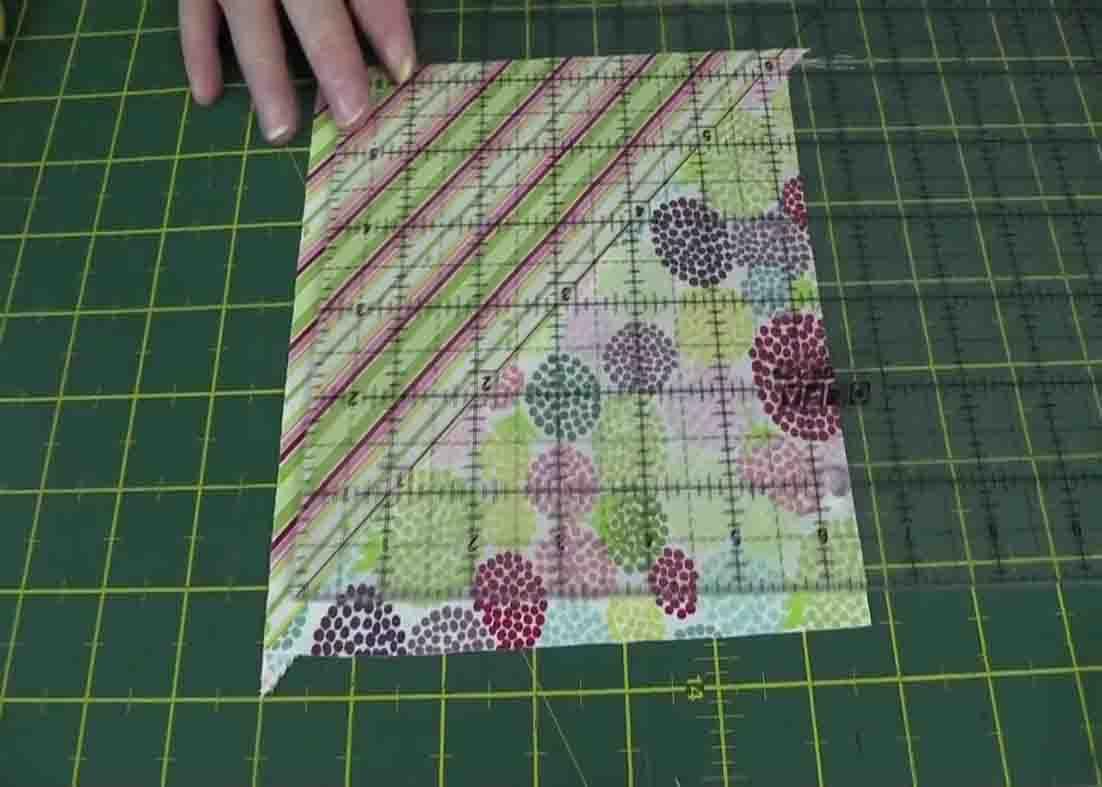Squaring up a half square triangle with a 45 degree angle ruler