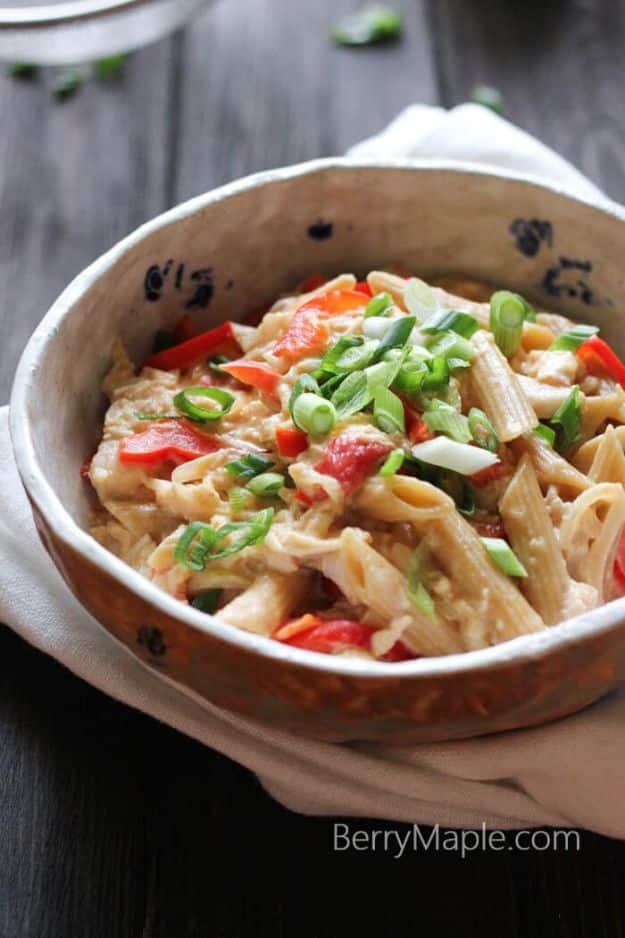 Rotisserie chicken cheese pasta with red bell pepper and cherry tomatoes in a creamy cheese sauce on a busy weeknight