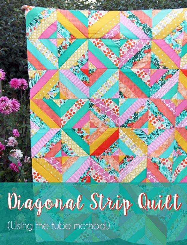 Diagonal strip quilt graphic, turquoise, pink and yellow diagonal blocks held up in front of pink dahlias