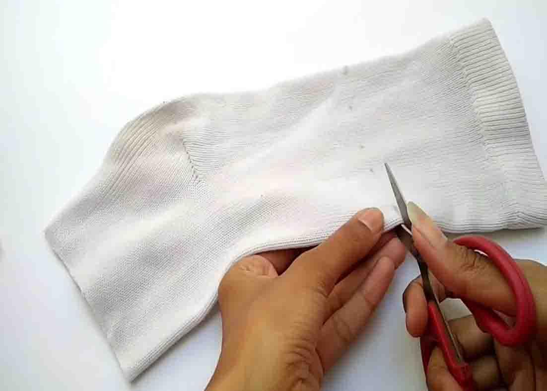 Cutting the sock to make the snowman