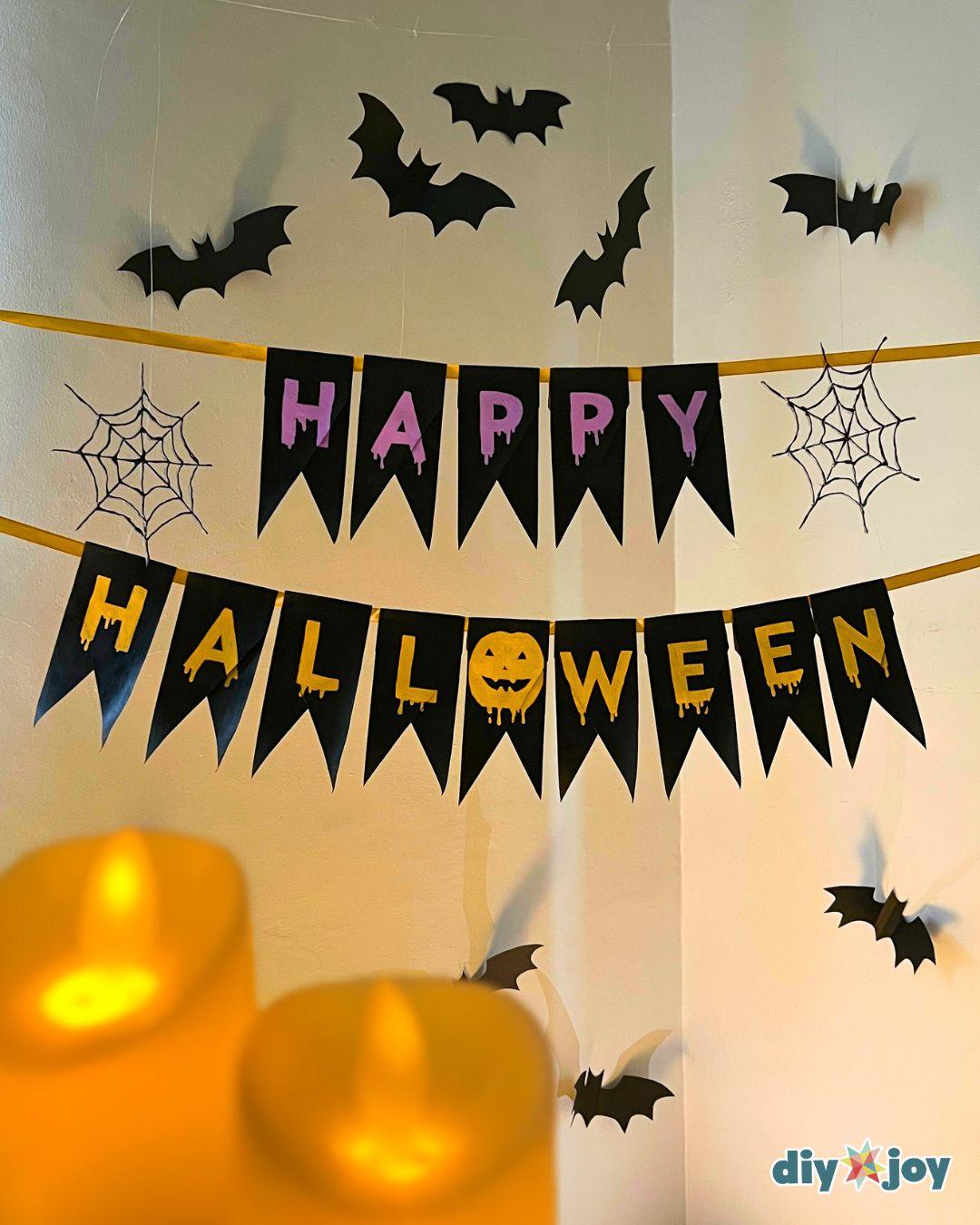 DIY Halloween decor - the handmade Halloween banner styled on display, made from recycled tubes and ribbon.