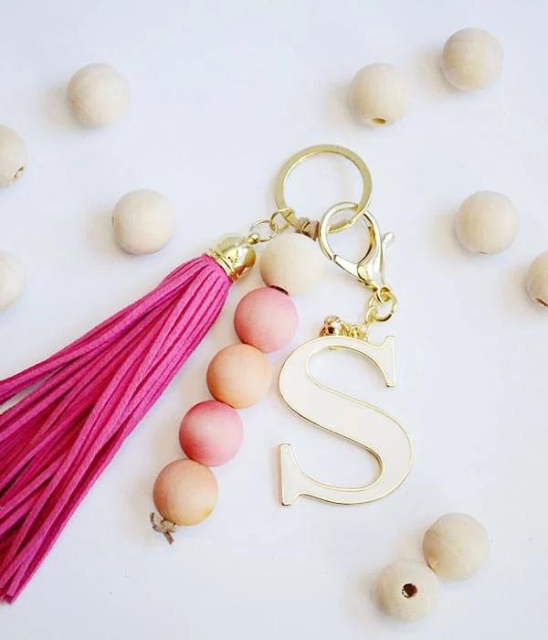DIY bead keychain strung from dyed wood beads in bold colors for a simple handmade accessory to carry daily