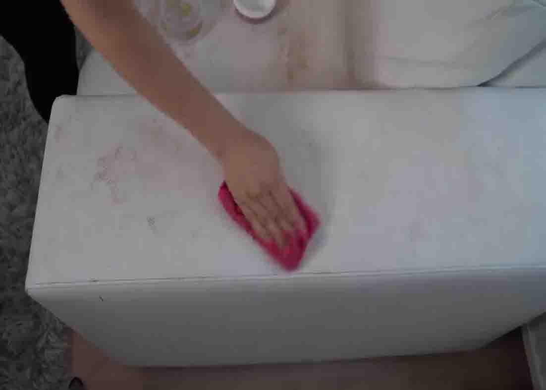 Cleaning the white couch with scrub daddy