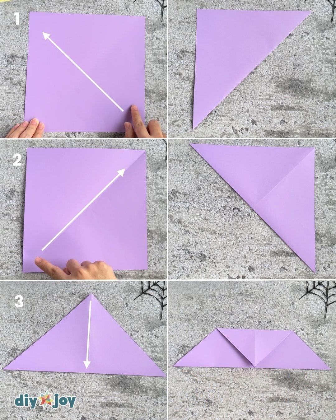 Origami bat step 1, folding the paper square in half diagonally. This is the first crease in the easy origami bat.
