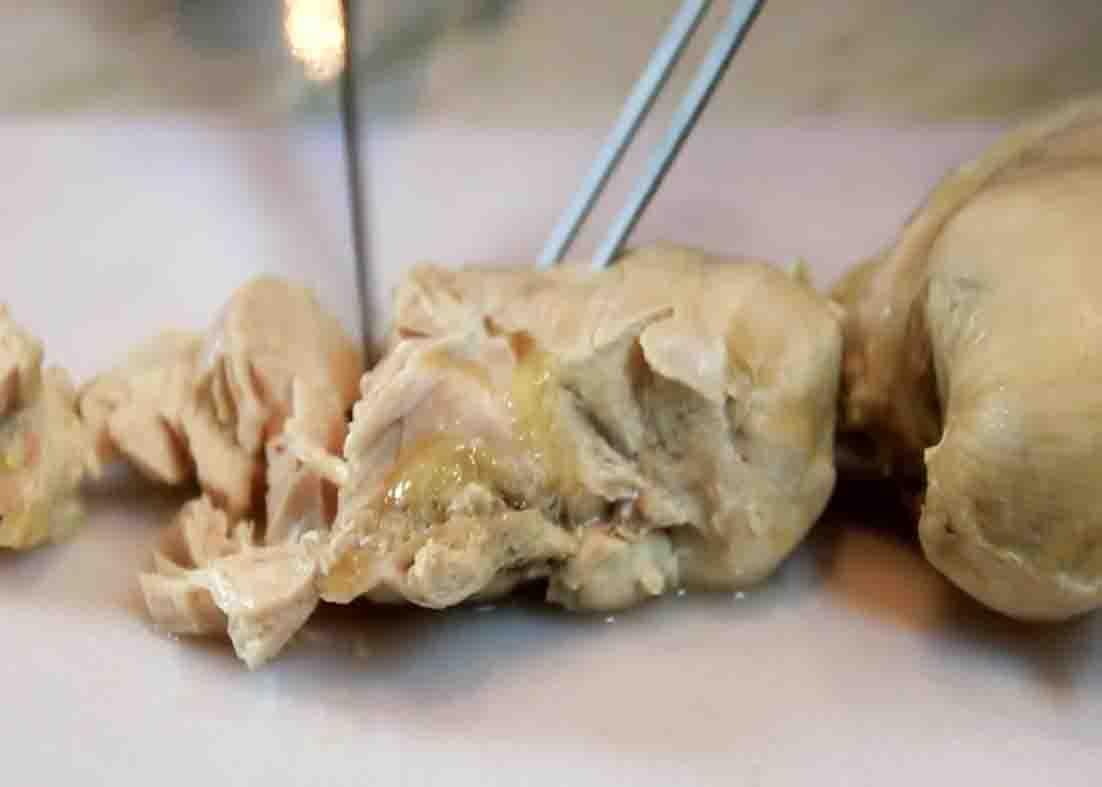 Cutting the chicken into bite-size pieces