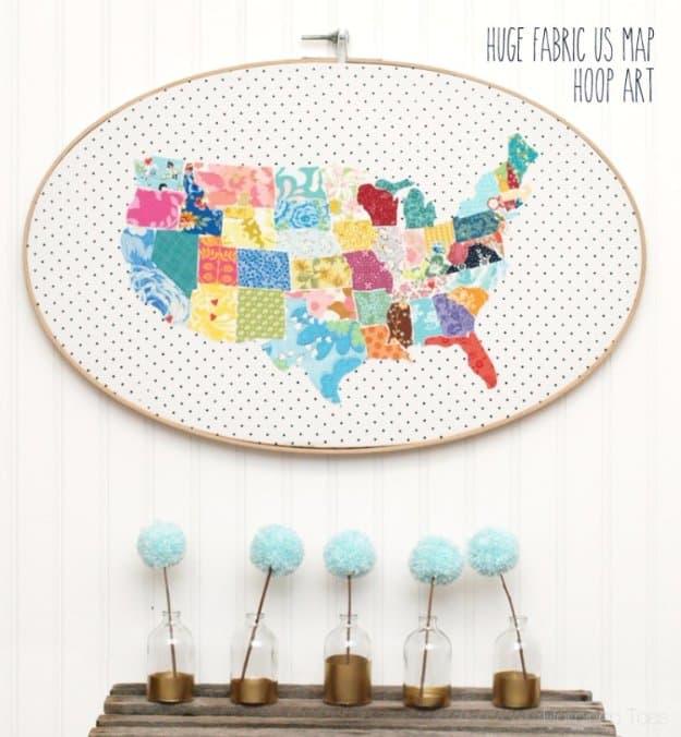 Large oval embroidery hoop holding a fabric United States map pieced from bright scraps on a dotted background