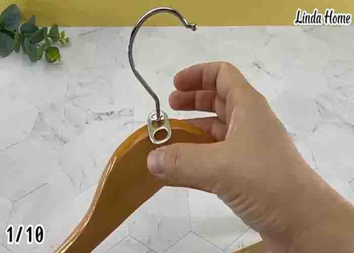 Attaching some soda can pull tabs on the hangers