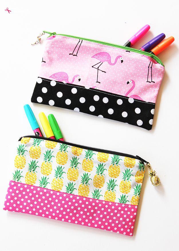 A lined zipper pencil pouch in a floral cotton print with a beaded zipper pull, sitting open on a sewing table.