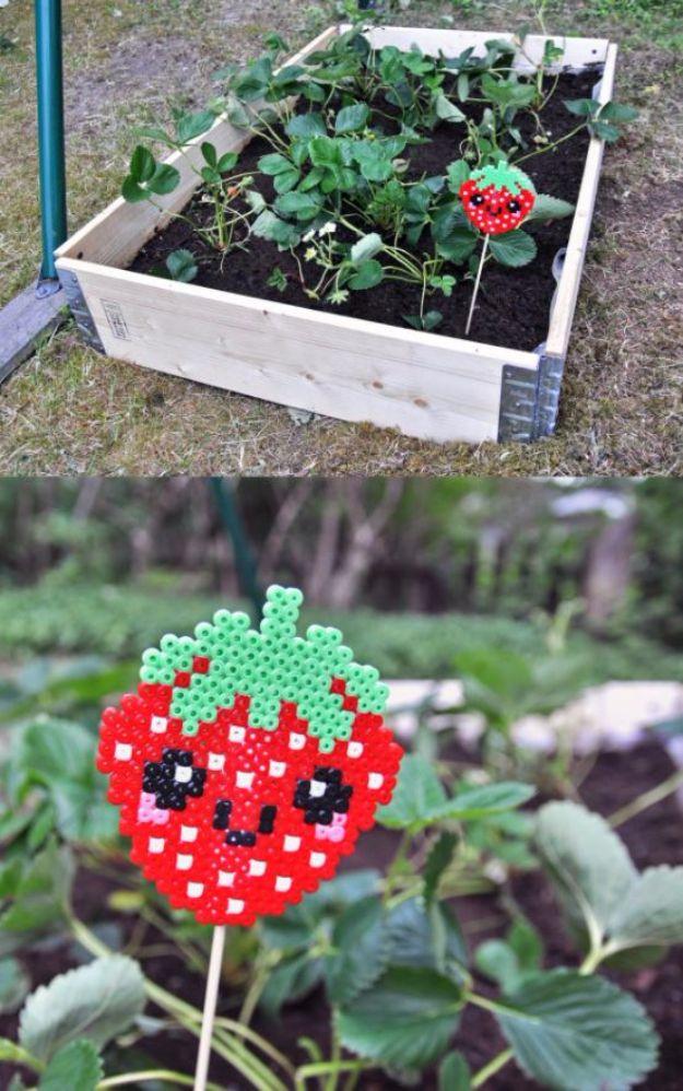 Beaded strawberry garden markers on wire stakes, a cute DIY bead craft idea for vegetable garden rows