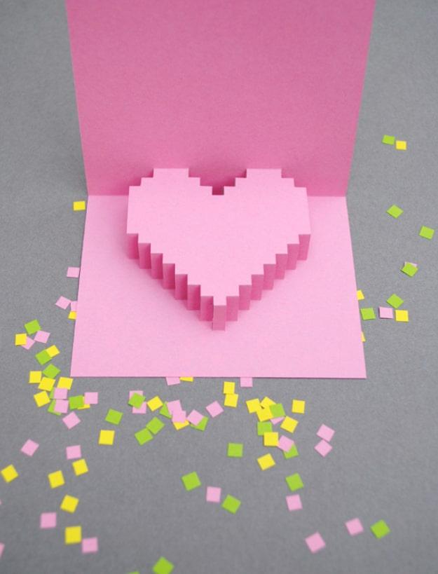 Pixelated pop up Valentine card with a blocky paper pixel heart standing upright out of the folded card
