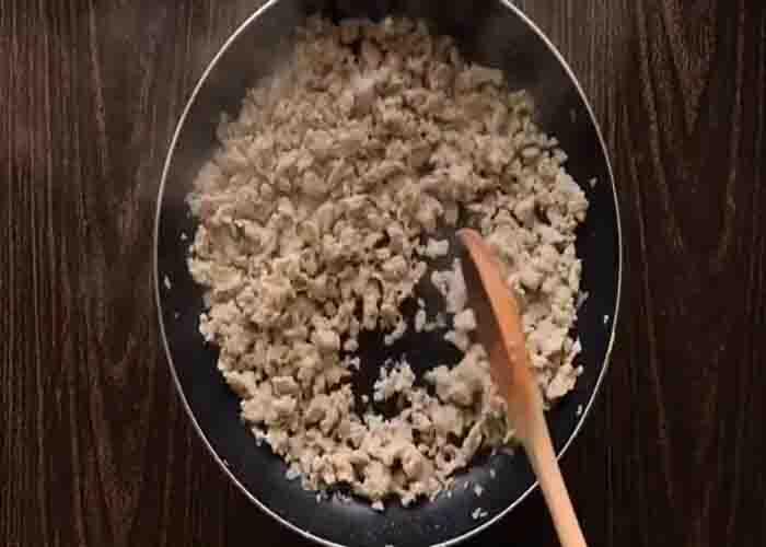 Cooking the ground chicken for the chicken and bread bake recipe